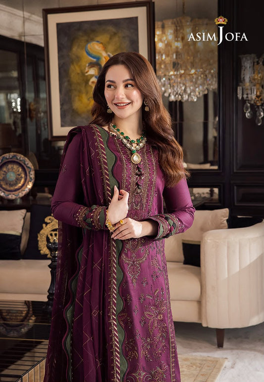 Woman in a purple traditional outfit with intricate patterns in a decorated room, featuring 'Asim Jofa' branding.